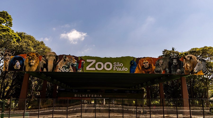 AquaRio Marinho do Rio de Janeiro - A large modern building with a blue facade and 'AquaRio' signage, showcasing the entrance to the aquarium with people walking nearby